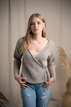 Our exquisite knitted linen wrap cardigan is crafted with meticulous attention to detail. This cardigan boasts a loose, relaxed fit, providing both ease of movement and style. The elegant V-neckline adds a touch of charm, framing the décolletage with grace and refinement. Its knitted lace ties, both inside and outside, ingeniously designed to cinch the waist and accentuate your figure. These ties not only highlight the waist but also add a touch of femininity to the overall design. Wear it over Beige Wrap Sweater For Layering, Linen Sweater For Spring Layering, Spring Wrap Cardigan In Beige, Long Sleeve Linen Sweater, Beige Wrap Cardigan For Layering, Beige Wrap Cardigan For Spring, Beige Wrap Cardigan For Summer, Spring Beige Wrap Cardigan, Summer Beige Wrap Cardigan