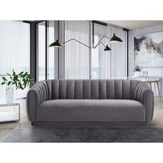 a gray couch sitting in front of a window