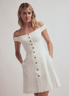 What's not to love about The Lovesick Dress? This mini version in White is crafted from a comfort cotton-blend and styled with off-the-shoulder neckline, faux horn buttons, and side pockets (!). The addition of back smocking creates a fitted bodice that is balanced with the A-line silhouette.98% Cotton 2% ElastaneCare Instructions:Machine wash cold gentle cycleLine dryLength from hps: 34 1/2" Megan is 5'10" wearing size 2 National Daughters Day, Daughters Day, Favorite Daughter, Navy Dress, White Mini Dress, Fitted Bodice, Navy And White, Horn, Smocking