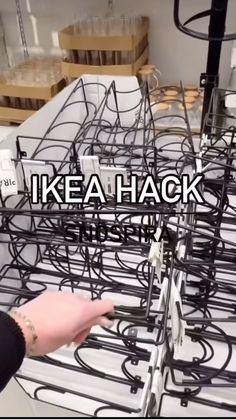 a person is touching the back of a rack with wires attached to it and words that read, ikea hack