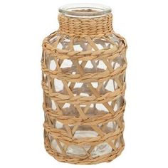 a wicker vase with a glass lid on a white background for use as a decoration