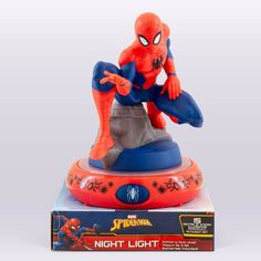 the amazing spider - man figurine is on display