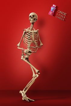 a skeleton standing in front of a red background with the caption's name on it