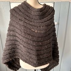 a woman's brown knitted shawl on a mannequin