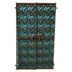 an old iron gate with scroll designs on it's sides and the door is open