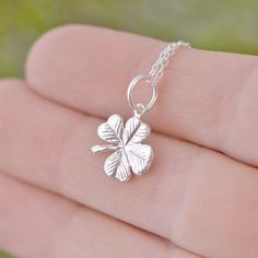 "Sterling Silver Four Leaf Clover A simple and elegant sterling silver Four Leaf Clover, a perfect lucky charm to wear during the day. We hand make these in our studio, then we attach a sterling jump ring to act as bail. The pendant includes a sterling silver curb chain. The Clover Charm is about 1/2 of an inch in length. You can choose the chain length - 16,18 or 20 inches. Are you new to Etsy? Shop my store and add your favorite items from The Jewelry Girls to your cart. Most of my items can b Dainty Flower Pendant Charm Necklace For Good Luck, Dainty Good Luck Flower Pendant Charm Necklace, Delicate Sterling Silver Charm Necklaces, Delicate Sterling Silver Charm Necklace, Dainty Round Pendant Charm Necklace For Good Luck, Delicate Sterling Silver Charms Jewelry, Dainty Good Luck Jewelry With Flower Pendant, Dainty Flower Pendant Jewelry For Good Luck, Elegant Sterling Silver Good Luck Charm Necklace