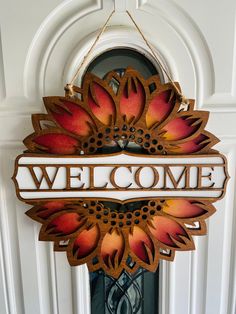 a welcome sign hanging on the front door