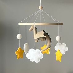 a mobile made to look like a baby's crib with toys hanging from it