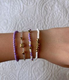 This pretty purple bracelet set is super cute and has a mix between purple and white with some gold accents. It is homemade and great quality! Trendy Purple Beaded Bracelets, Trendy Purple Beaded Bracelets For Everyday, Everyday Purple Beaded Bracelets, Trendy Everyday Purple Beaded Bracelets, Trendy Purple Friendship Bracelets, Purple Round Beads Friendship Bracelets, Everyday Purple Beaded Stretch Bracelet, Everyday Purple Jewelry With Letter Beads, Bracelets Purple