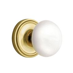 an image of a white door knob on a gold door handle with a white ball