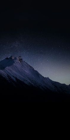 the night sky is filled with stars above a snowy mountain