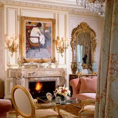 a fancy living room with chandelier and fireplace