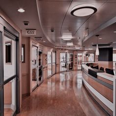 the interior of a modern office building with wood flooring and glass doors on both sides