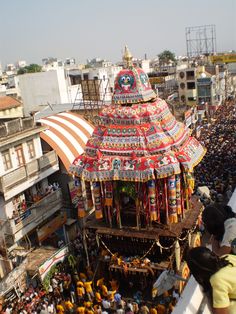 an elaborately decorated building in the middle of a crowded street with lots of people