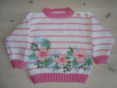 Handknitted babysweater, pink and white with flowers Cute Hand Knitted White Sweater, Cute White Hand Knitted Sweater, Cute Handmade White Sweater, Cute White Handmade Sweater, Handmade Pink Sweater For Spring, Cute Hand Knitted Pink Sweater, Cute Pink Crochet Knitting Pattern, Cute Pink Crochet Sweater, Crochet Baby Sweater Pattern