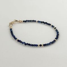 Elevate your style with this royal blue Lapis Lazuli Bracelet, a dainty gemstone beaded jewelry piece that's as elegant as it is versatile. This skinny blue stone bracelet is not only a stunning accessory but also serves as a meaningful September birthstone gift, making it a perfect choice for a birthday celebration or a memorable 9th anniversary gift for women, mom, girlfriend, teacher, sister, bridesmaid or bride. With its deep blue hues and natural beauty, this Lapis Lazuli bracelet is sure t Dainty Blue Beaded Round Bracelets, Dainty Blue Faceted Beaded Bracelets, Dainty Blue Beaded Bracelets, Dainty Blue Round Beaded Bracelets, Everyday Lapis Lazuli Jewelry With Gemstone Beads, Blue Dainty Birthstone Bracelets, Elegant Lapis Lazuli Bracelets For Gifts, Adjustable Blue Bracelets With Birthstone, Sapphire Beaded Lapis Lazuli Bracelets For Gifts