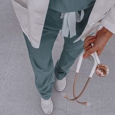 a person standing on the ground with a stethoscope in their hand