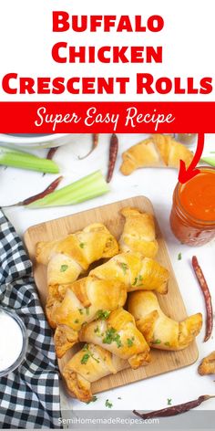 buffalo chicken crescent rolls on a cutting board with dipping sauce in the background and text overlay reading buffalo chicken crescent rolls super easy recipe