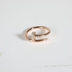 a gold ring with two diamonds on it