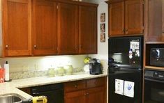 a kitchen with wooden cabinets and black appliances