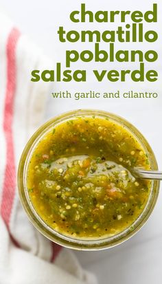 a jar filled with salsa next to a white towel