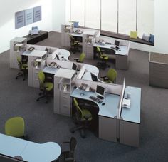 an office cubicle with desks and computers