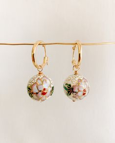 ✤14kt gold filled hoops: 15mm ✤cloisonné charms: 18mm  Artful and eye-catching vintage inspired gold cloisonné drop hoop earrings featuring white floral enamel charms. Small gold filled hoops latch securely.  SHIPPING: ✤I offer FREE shipping within Canada but please note that this does NOT include tracking. If you choose FREE shipping, you risk your package getting lost in transit. If this happens, I CANNOT issue you a refund or replace your jewelry. ✤Only TRACKED orders include tracking. This option is the ONLY method of shipping that ensures you will receive your package or that you can receive a full refund or replacement should your package go missing. GOOD STUFF ✤Become an A/R INISIDER at https://adornedbyruth.com/ to get first peeks at new releases & discounts  ✤Instagram: @adornedby Hoops With Charms, Cloisonne Enamel Jewelry, Embossed Jewelry, Drop Hoop Earrings, All That Glitters Is Gold, Beautiful Abstract Art, Enamel Beads, Gold Filled Hoops, Cloisonne Enamel