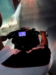 a person on a motorcycle driving down a street at high speed with an electronic screen showing the time