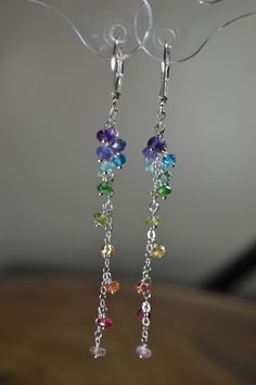 "These Long Ombre Rainbow Cluster Earrings present gemstones in a minimal and timeless way. The gemstones display the colors of the rainbow (and them some) as they descend. These Earrings are a perfect addition to your everyday attire and suitable for all special occasions, from weddings to special events. Each gemstone displays a lot of beauty and energy. Though these earrings are designed to be minimalist, their color is still impactful and they are sure to brighten your day! >Rainbow, Rain Modern Handmade Rainbow Jewelry, Rainbow Sterling Silver Jewelry With Ear Wire, Elegant Rainbow Jewelry With Matching Earrings, Rainbow Elegant Jewelry Set With Matching Earrings, Elegant Rainbow Dangle Jewelry, Rainbow Sterling Silver Dangle Jewelry, Rainbow Sterling Silver Earrings, Rainbow Gemstone Jewelry In Sterling Silver, Fine Jewelry Gemstone Linear Earrings As Gift