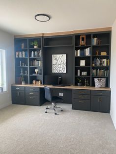 an office with built in bookshelves and desk