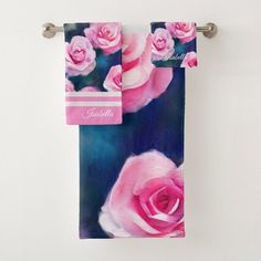 two towels hanging on the wall with pink roses