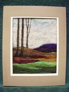 an image of a painting on the wall in a frame with green grass and trees