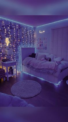 a bedroom decorated in purple and white with lights on the walls