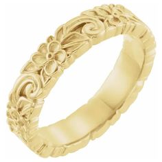 a gold wedding band with flowers on it