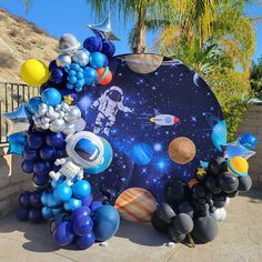 an image of balloons and space themed decorations