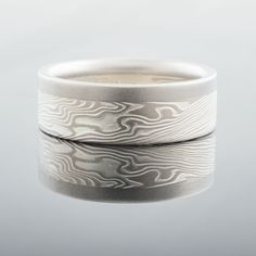 "This stunning 5mm Mokume Gane ring is shown in the Twist pattern and the Ash Palette with a low dome profile, etched finish, and added 2mm palladium rail. The Ash palette features Palladium and Sterling Silver. Pattern: Twist Palette: Ash Finish: Lightly Etched Profile: Low Dome Width: 5mm Added: 2mm palladium rail Price does NOT include stones or setting fees. We care about customer service and would like to hear from you! Please contact us to help create your treasured item, we take your conc Mokume Gane Ring, Twist Pattern, Mokume Gane, Custom Wedding Rings, Large Ring, Small Rings, Size 10 Rings, Solid Metal, Precious Metals