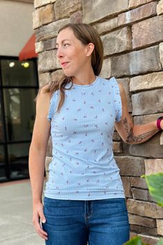 Sweet and feminine floral sleeveless top with flutter ruffled detail on the sleeve armholes. Made with soft and stretchy fabric in a light blue color. 95% Polyester / 5% Spandex Fit Notes: This top runs small. We recommend sizing up one. ----------- NOTE: All items with prices ending in .19 are considered closeout/clearance items that we will not be restocking. Last chance -- get it for a steal! (No returns or exchanges on .19 priced FINAL SALE items.) Light Blue Casual Tops With Ruffle Sleeves, Casual Light Blue Tops With Ruffle Sleeves, Casual Light Blue Ruffle Sleeve Tops, Light Blue Ruffle Sleeve Top For Spring, Sleeveless Light Blue Floral Print Top, Feminine Blue Top With Flutter Sleeves, Feminine Blue Flutter Sleeve Top, Blue Feminine Top With Ruffle Sleeves, Blue Feminine Tops With Ruffle Sleeves