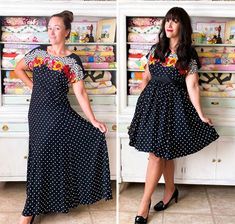 a woman in a polka dot dress standing next to a shelf full of fabric items