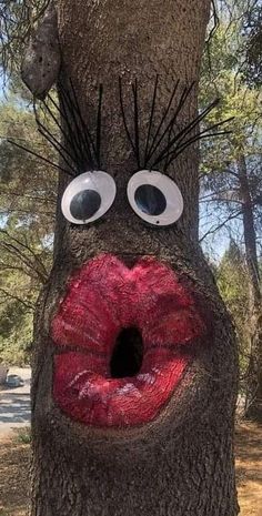 a tree with a mouth and tongue painted on it