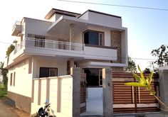 a motorcycle parked in front of a two story house