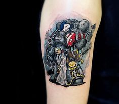 a tattoo on the arm of a person with an image of a robot and two people