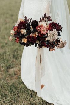 a bride holding a bouquet of flowers in her hand