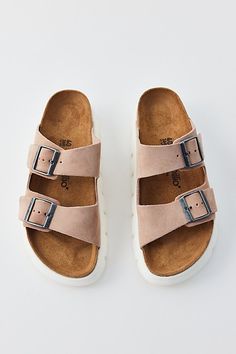 Suede Birkenstock Arizona sandals updated with a chunky flatform lug sole. Features Birkenstock Arizona chunky suede sandals An update to the iconic Birkenstock sandals Double-strap upper Contoured cork footbed Plenty of comfy arch support Deep lugged sole Slip-on style Content + Care Suede, cork, rubber Spot clean Imported Size + Fit Platform: 1.5" | Birkenstock Arizona Chunky Suede Sandal in Warm Sand, Women's at Urban Outfitters Pink Clay Birkenstock, Birkenstock Arizona Chunky, Beige Slip-on Sandals With Textured Sole, Beige Slip-on Platform Sandals, Birkenstock Sandals Arizona, Beige Buckle Closure Slip-on Footbed Sandals, Birkenstock Sandals, Birkenstock Arizona, Suede Sandals