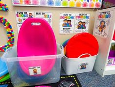 colorful toys are sitting in plastic containers on the floor