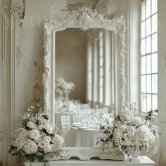 a white table with flowers and a mirror