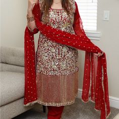 Red Suit Covered In Custom Work With Trousers And Dupatta Red Dupatta With Dabka Work, Festive Red Dupatta With Dabka Detail, Red Semi-stitched Salwar Kameez For Celebration, Red Dabka Embroidered Dupatta For Festivals, Red Dupatta With Dabka For Festivals, Red Dabka Dupatta For Festivals, Red Dabka Salwar Kameez, Red Salwar Kameez With Dabka For Celebration, Red Traditional Wear With Dabka For Party