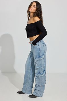 These baggy fit jeans sit low on the hips and come with a bigger, full-length leg that bunches at the bottom. Perfect for your biggest sweater or your tiniest shirt. We're so in our bag rn. Features - Nine-pocket styling - Cargo pockets - Zip-fly with button closure Size & Fit - Fit: Relaxed - Rise: 10.5" - Inseam: 33" - Model is wearing size 3 Materials & Care - Content: 75% cotton, 25% organic cotton - Care: Wash cold, inside out - Imported Baggy Cargo Jeans, Baggy Medium Wash Cargo Jeans, Baggy Washed Blue Cargo Jeans, Baggy Mid-rise Denim Blue Cargo Jeans, Faded Baggy Denim Cargo Jeans, Baggy Blue Rigid Denim Cargo Jeans, Tiny Shirts, Baggy Jeans For Women, Big Sweaters