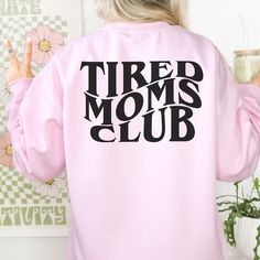 Cozy up in this ultra-soft Tired Moms Club Sweatshirt! Perfect for a snuggly night in, this stylish layering piece features a classic design for an effortlessly chic look. You'll show the world that yeah, you're tired...but you're still #momboss. ♥ We want you to be happy with your item, and for it to bring you joy! If you have any problems with your order or your item, please contact us prior to leaving a review. We will do what we can to take care of you and ensure that you are a happy customer. If you are satisfied, we would be over the moon if you could take the time to leave us a great review! ♥Thank you so much for supporting our small female-run business! Trendy Super Soft Long Sleeve Tops, Trendy Long Sleeve Lounge Sweater, Trendy Long Sleeve Lounging Sweater, Trendy Long Sleeve Super Soft Top, Trendy Spring Sweater For Lounging, Trendy Crew Neck Sweatshirt For Loungewear, Trendy Winter Sweater For Lounging, Crew Neck Tops For Lounging In Winter, Crew Neck Top For Winter Lounging