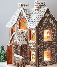 a gingerbread house is lit up for christmas