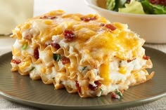 a casserole dish with cheese, bacon and spinach in it on a plate